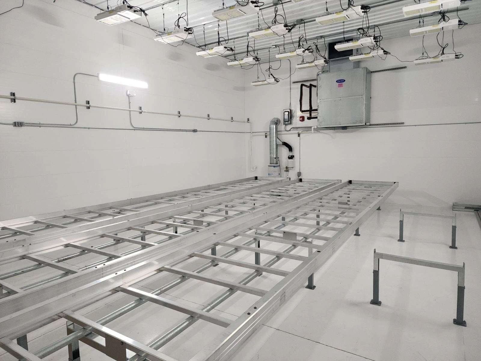 Commercial facility interior with structural steel framing and overhead conduit