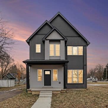Modern two-story gray custom home at sunset